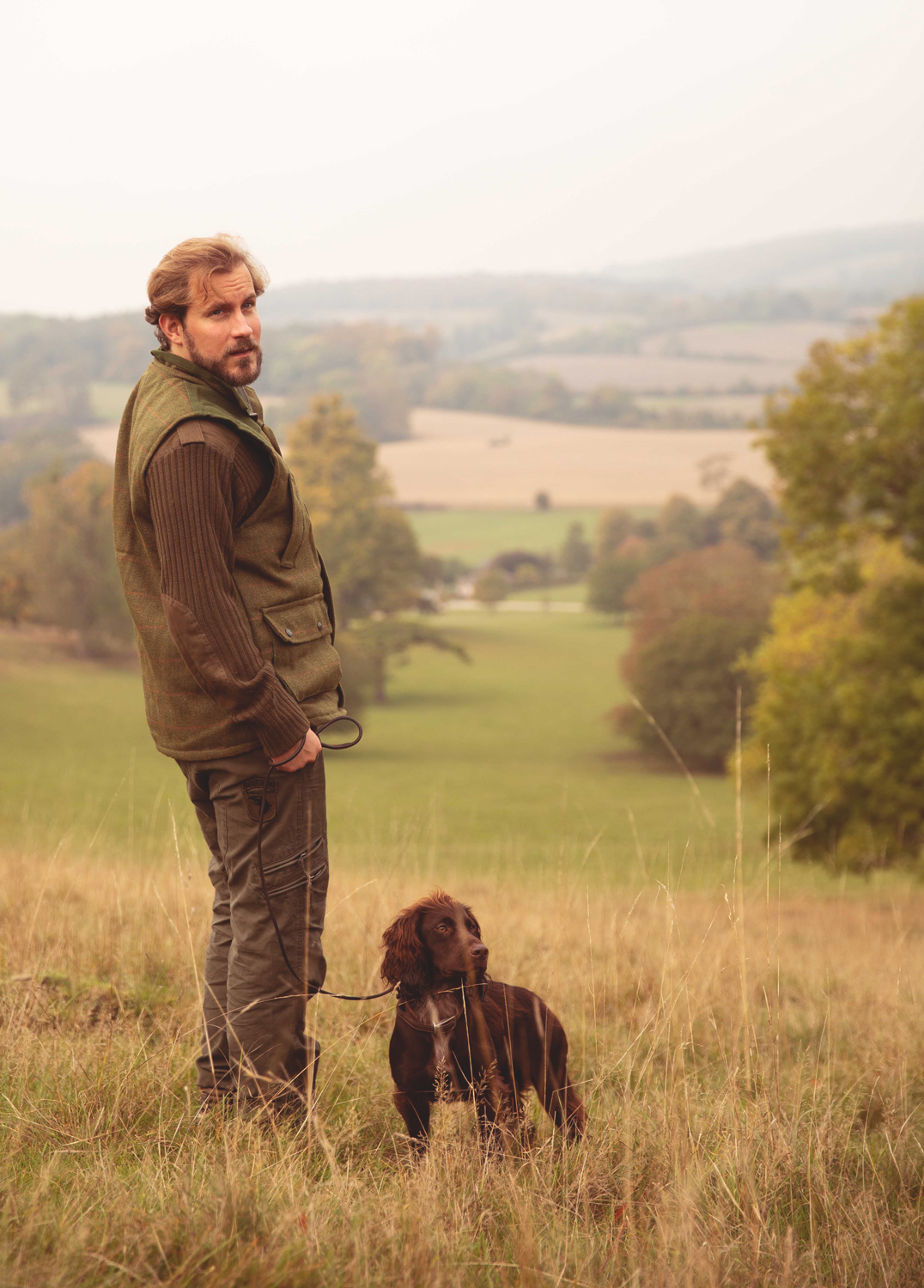 Man standing on a field with his dog